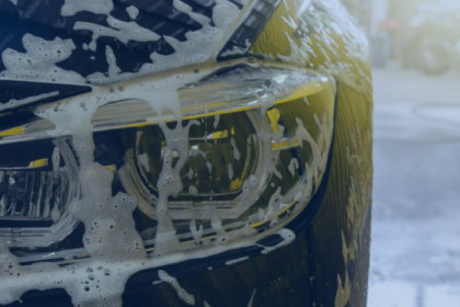 Photo of a car with suds on the front end.