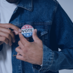 Photo of a voter wearing a Vote pin.